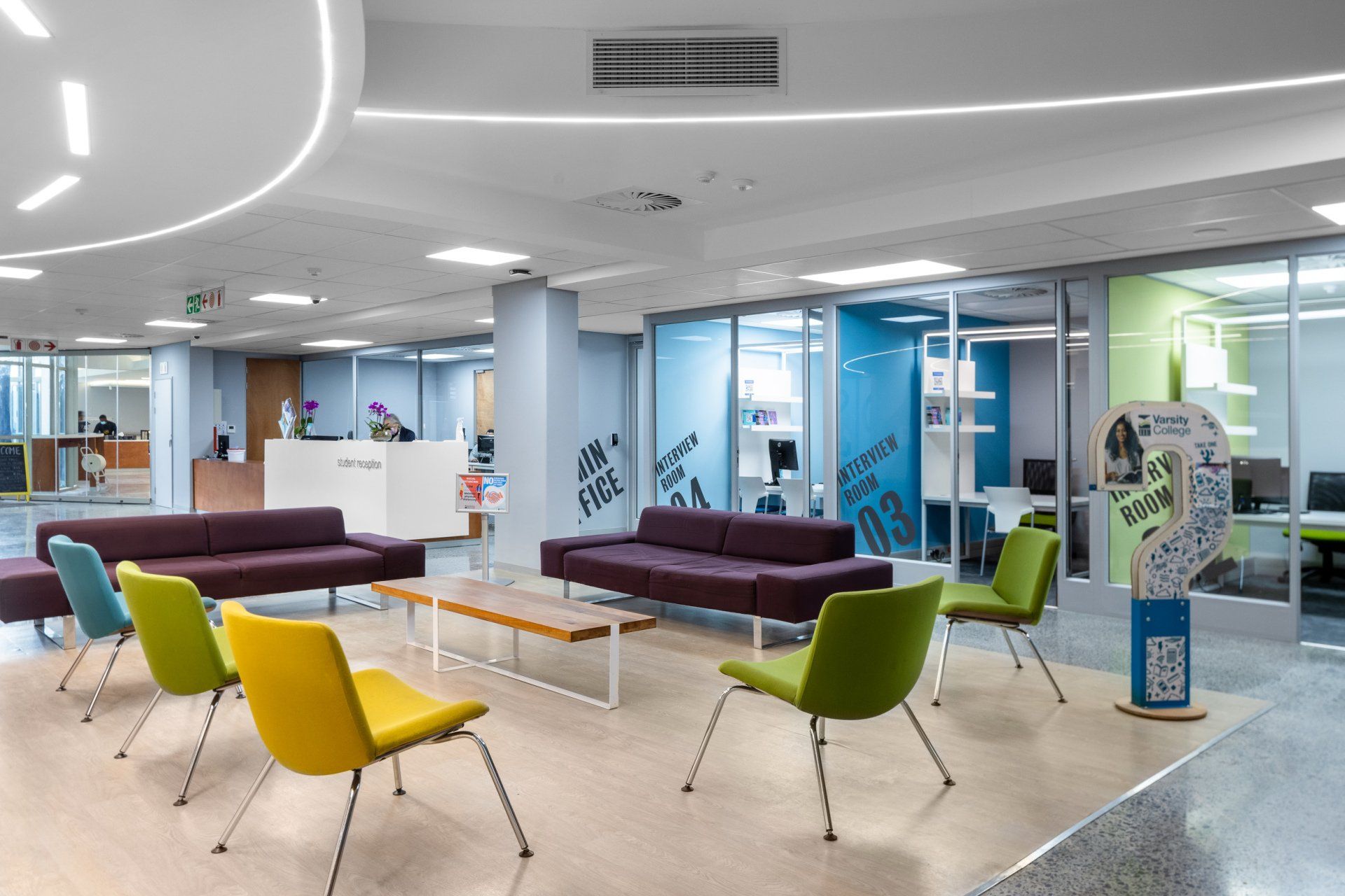 A living room with a couch , chairs , and a table.