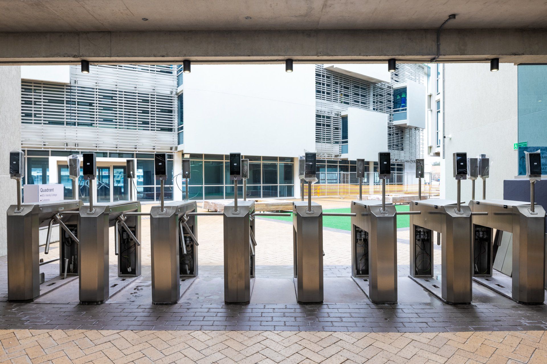 A row of turnstiles in front of a building