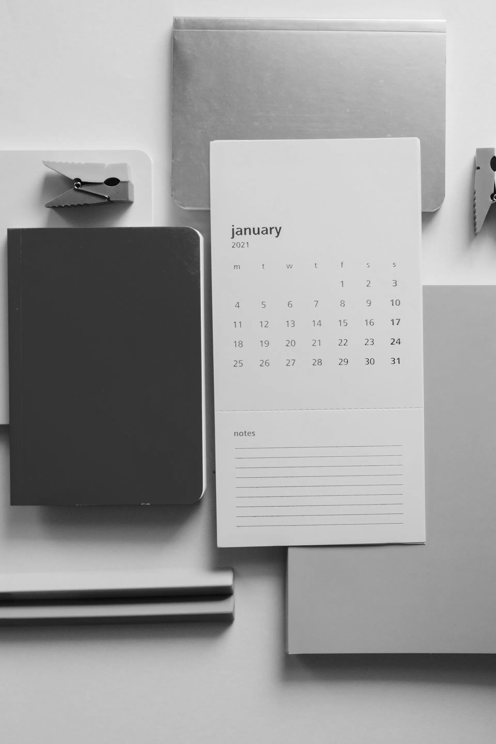 A black and white photo of a calendar on a table