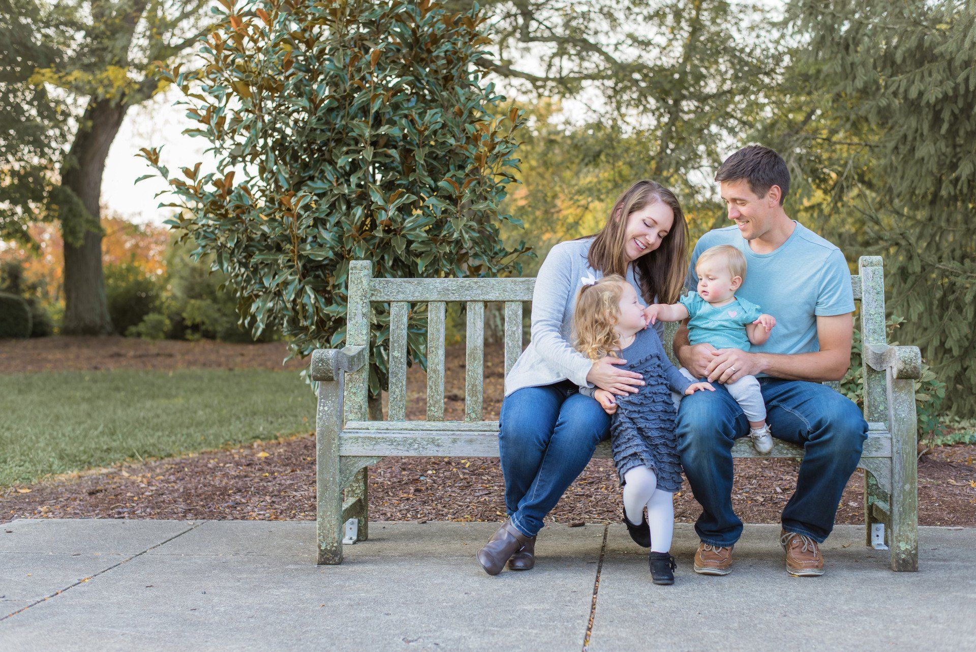 Dr. Annie Enzweiler and her family on park bench image