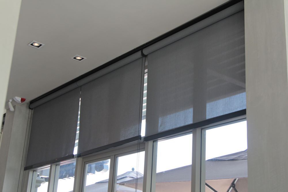 A Large Window With Roller Blinds on It — Aussie Carpets & Vinyl In Maleny, QLD