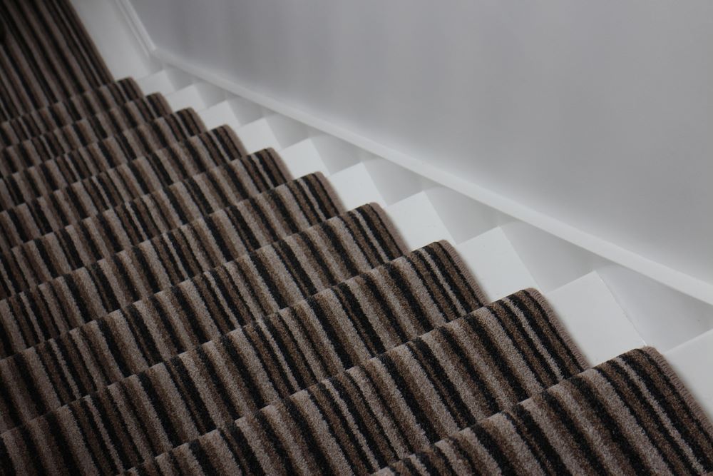 A Close Up of a Staircase With a Brown and Black Striped Carpet — Aussie Carpets & Vinyl In Maroochydore, QLD