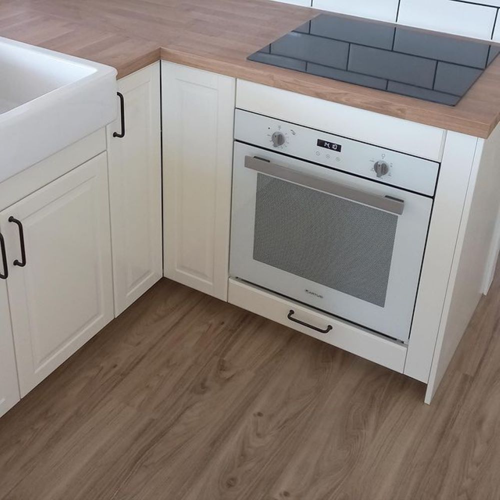 A Kitchen With a Stove Top Oven and a Sink — Aussie Carpets & Vinyl In Maroochydore, QLD