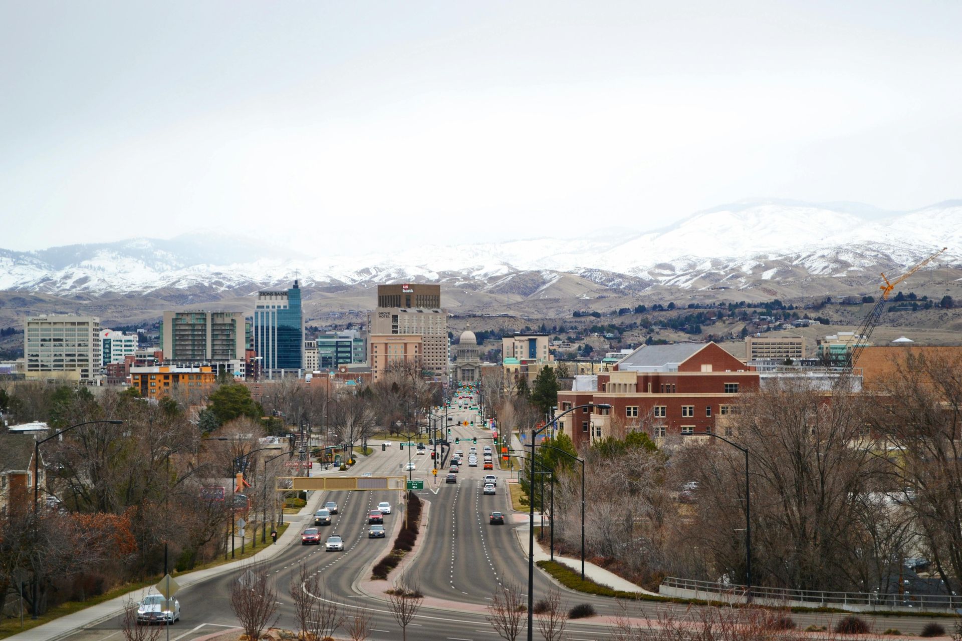 An aerial view of a city with mountains in the background.