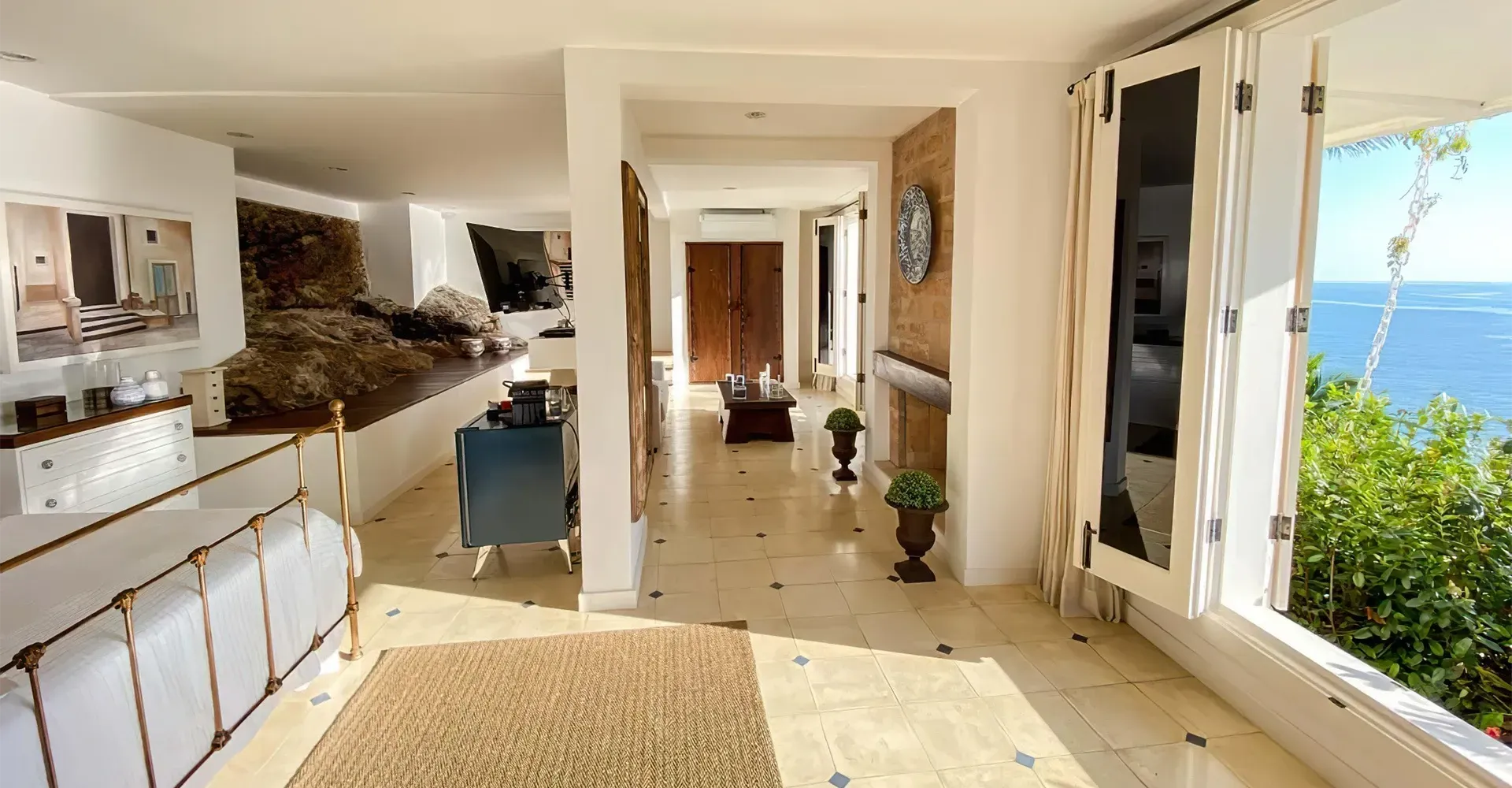 Um longo corredor em uma casa com vista para o oceano.