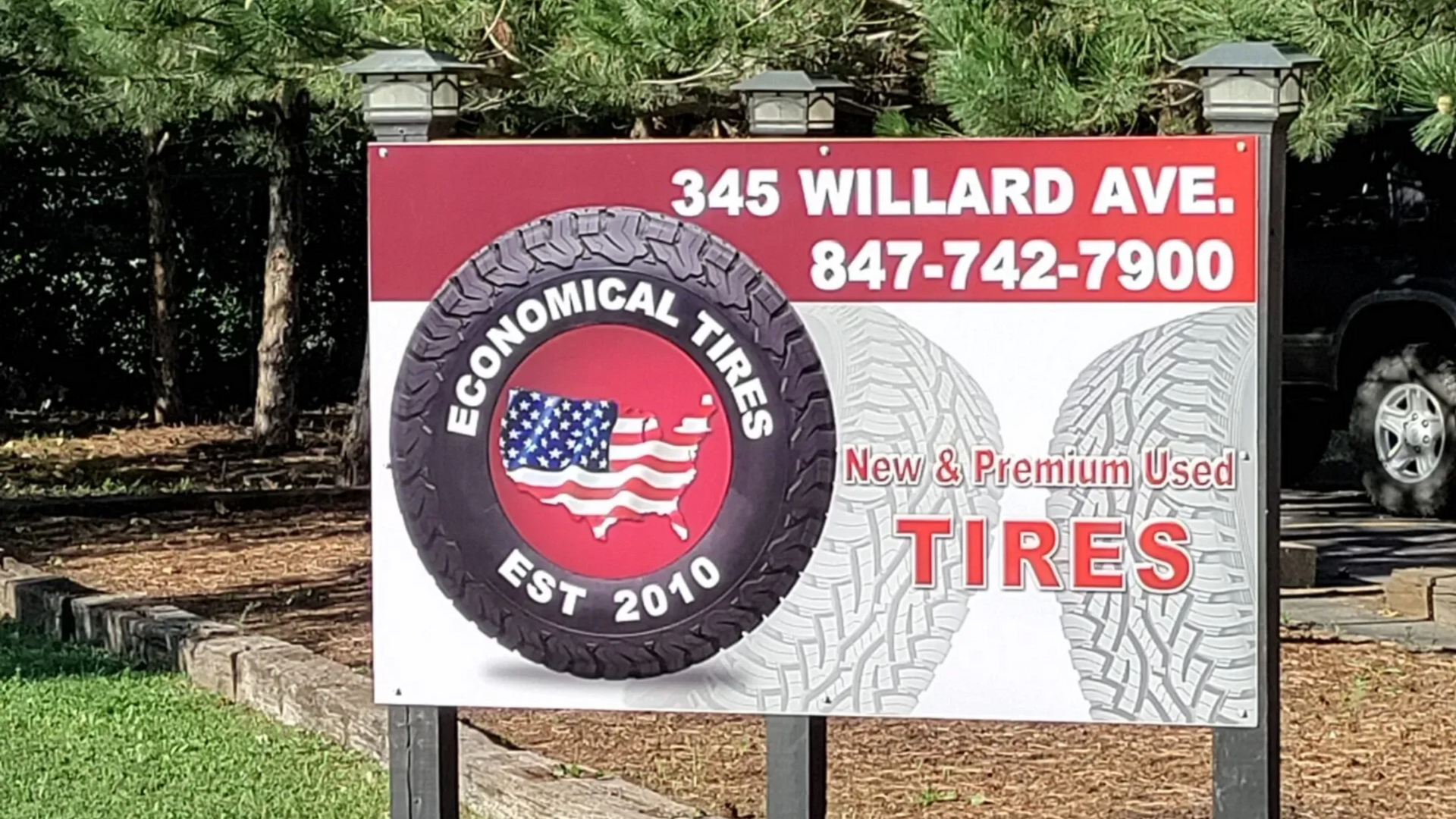 Sign for Economical Tires, 345 Willard Ave., offering new & used tires. Features tire graphic with American flag.