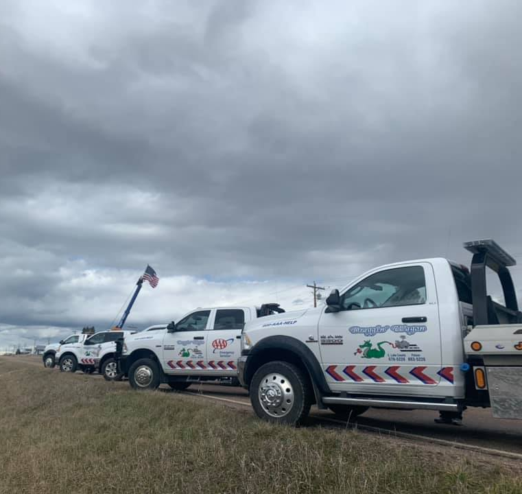 Cars Are Parked In A Grass – Mission Valley, MT – Draggin' Wagon Towing