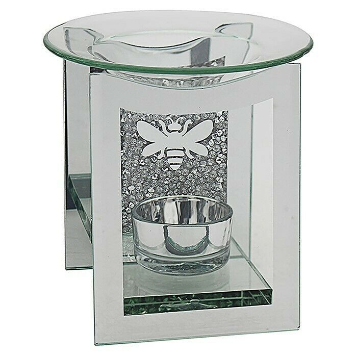 A glass oil burner with a bee design on it.