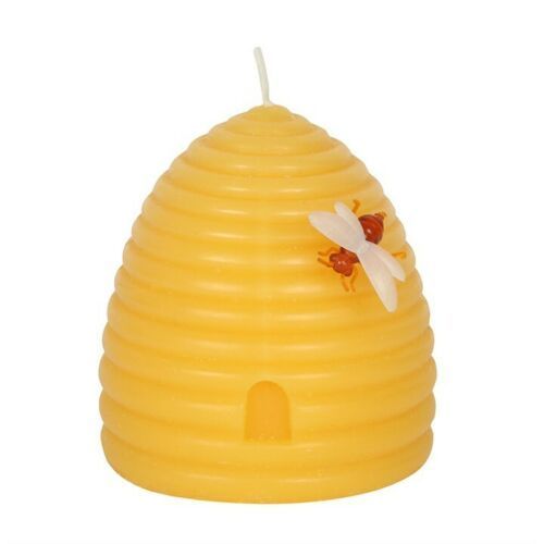 A beehive shaped candle with two bees on it