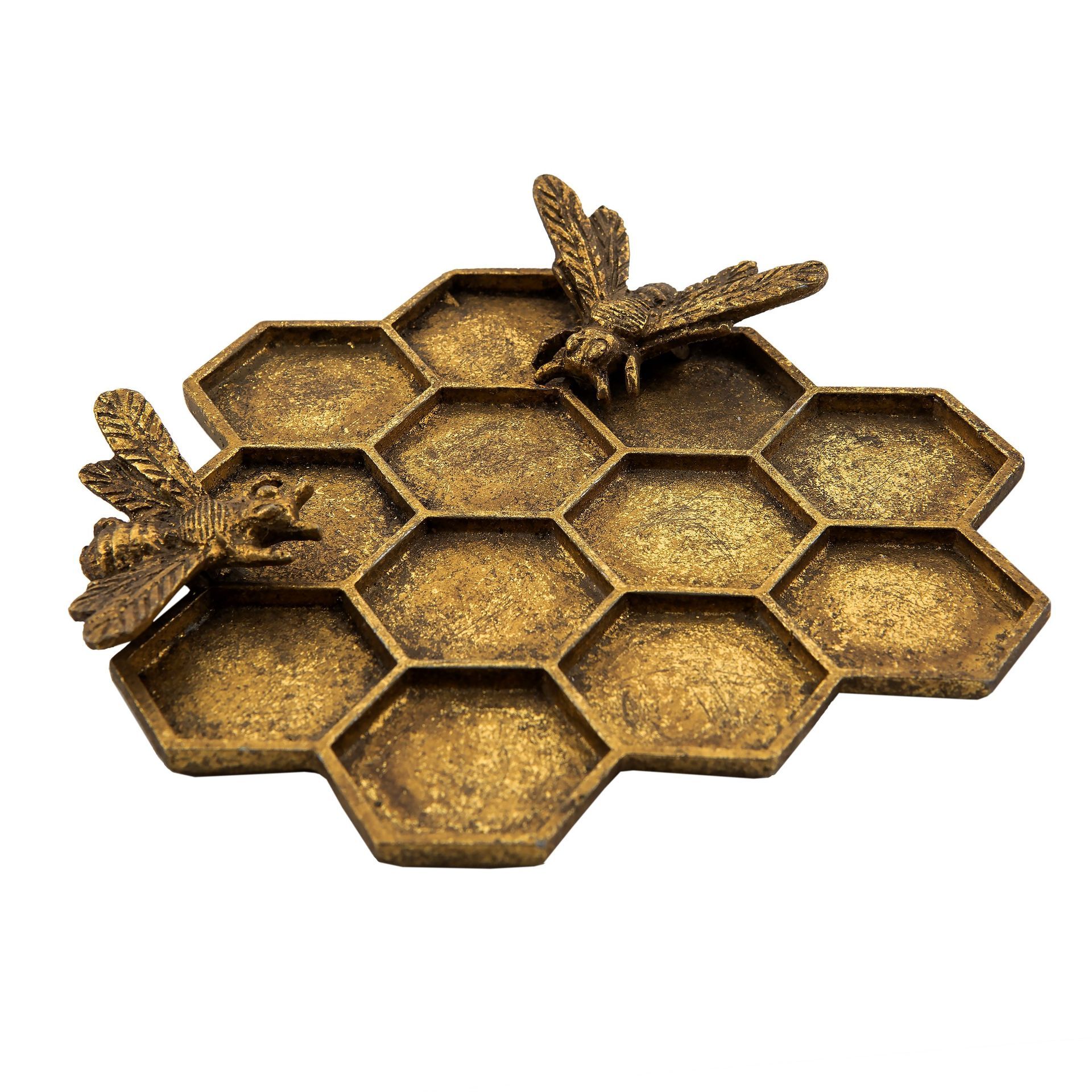 A honeycomb shaped tray with two bees on top of it