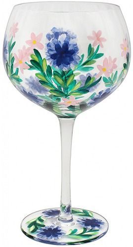 A wine glass with flowers painted on it on a white background.