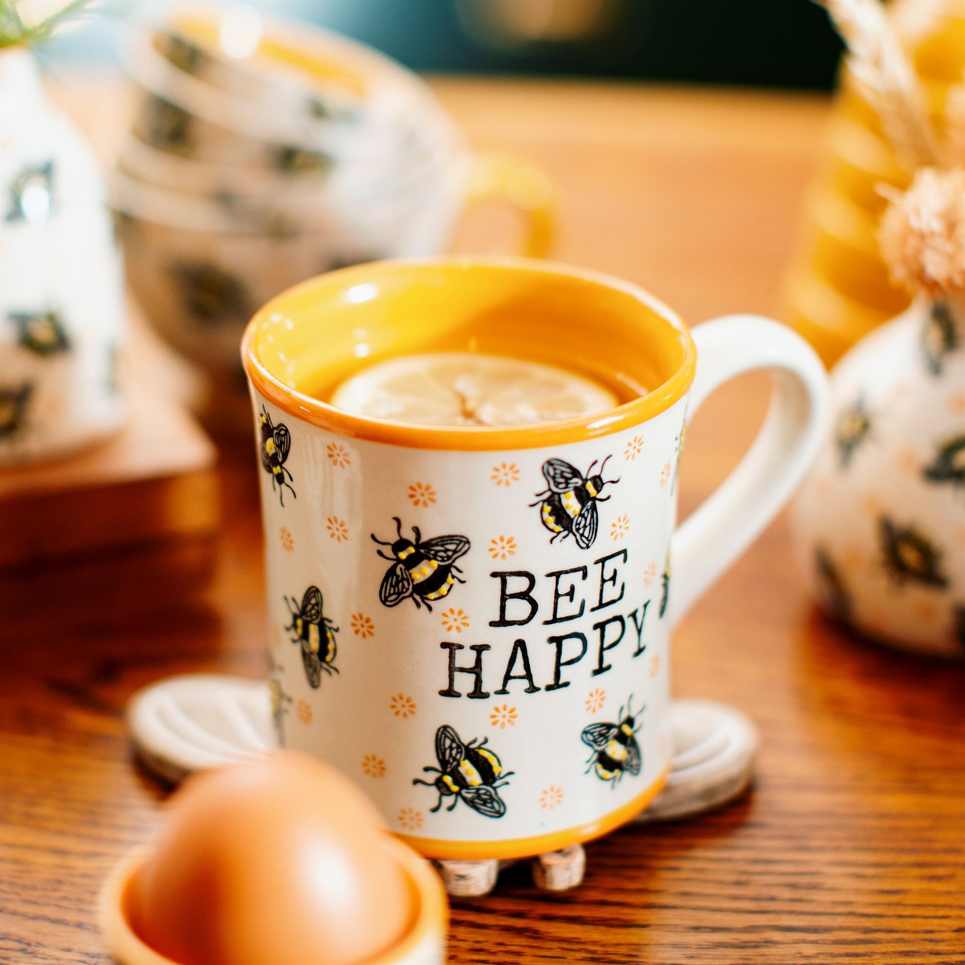 A mug that says bee happy with bees on it