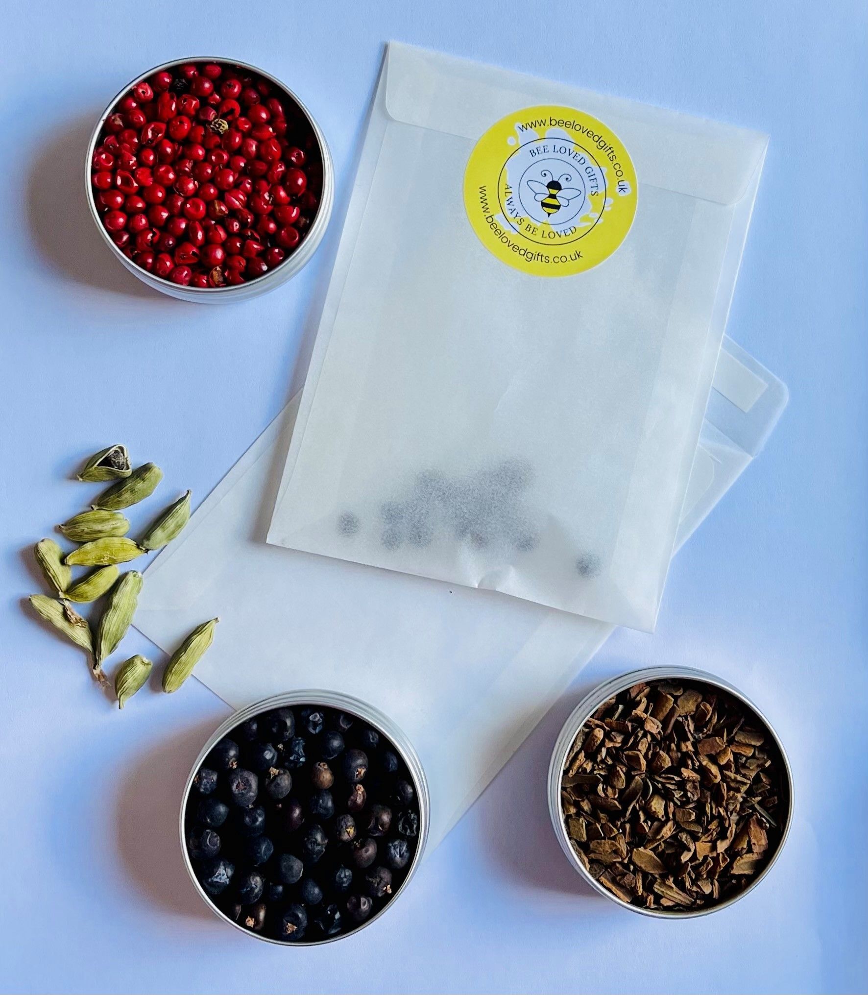 A bag of spices is surrounded by bowls of spices