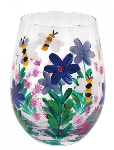 A wine glass with flowers and bees painted on it