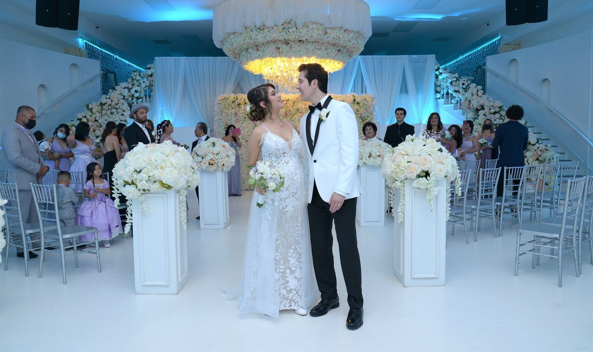 A bride and groom are posing for a picture at their wedding ceremony.