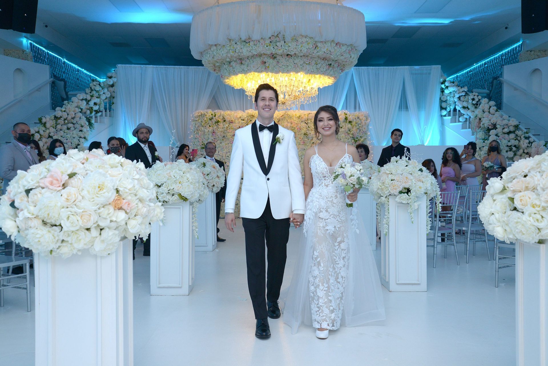 A bride and groom are walking down the aisle at their wedding.