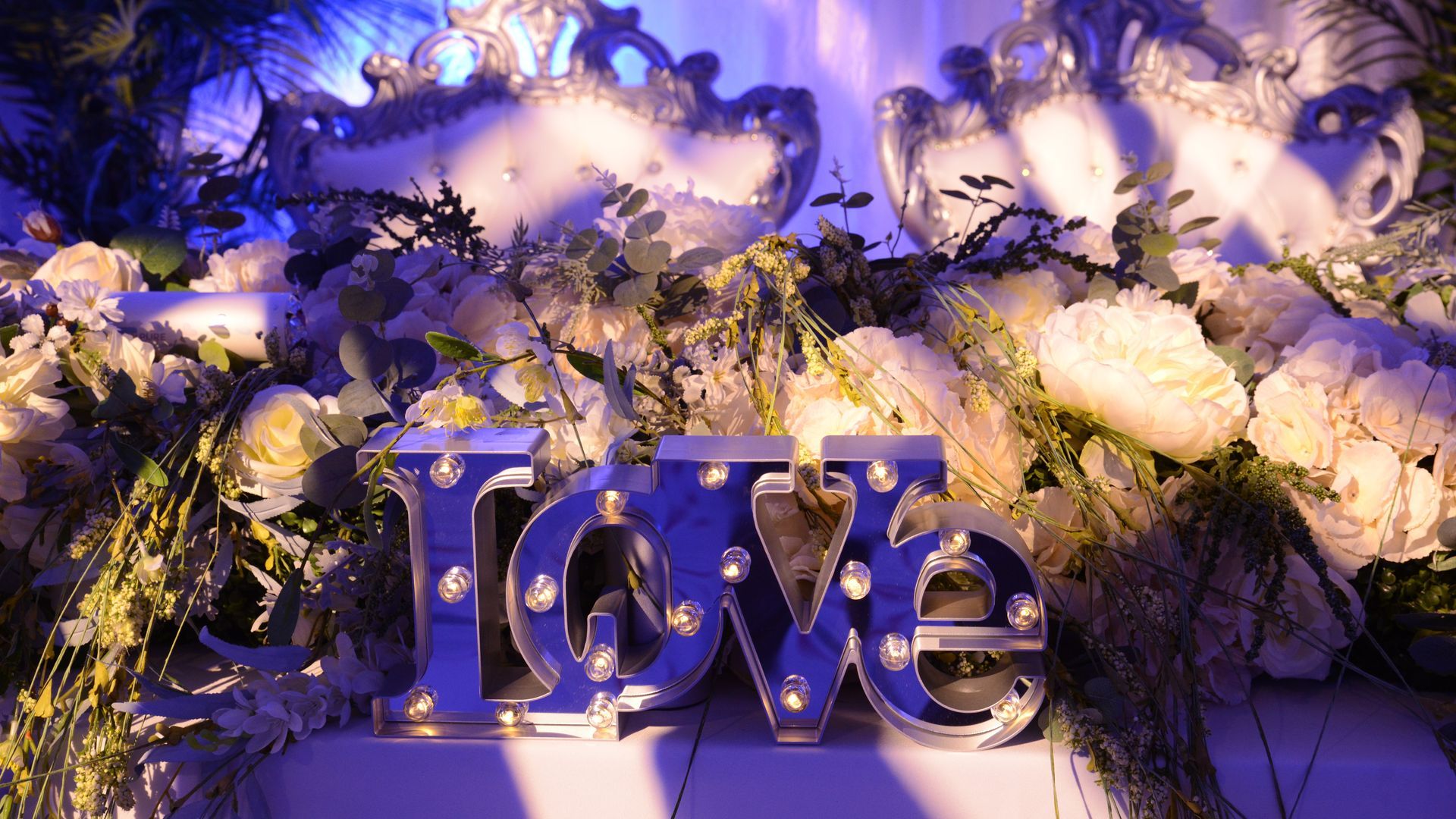 A table set for a baby shower with plates , glasses , and a cake.