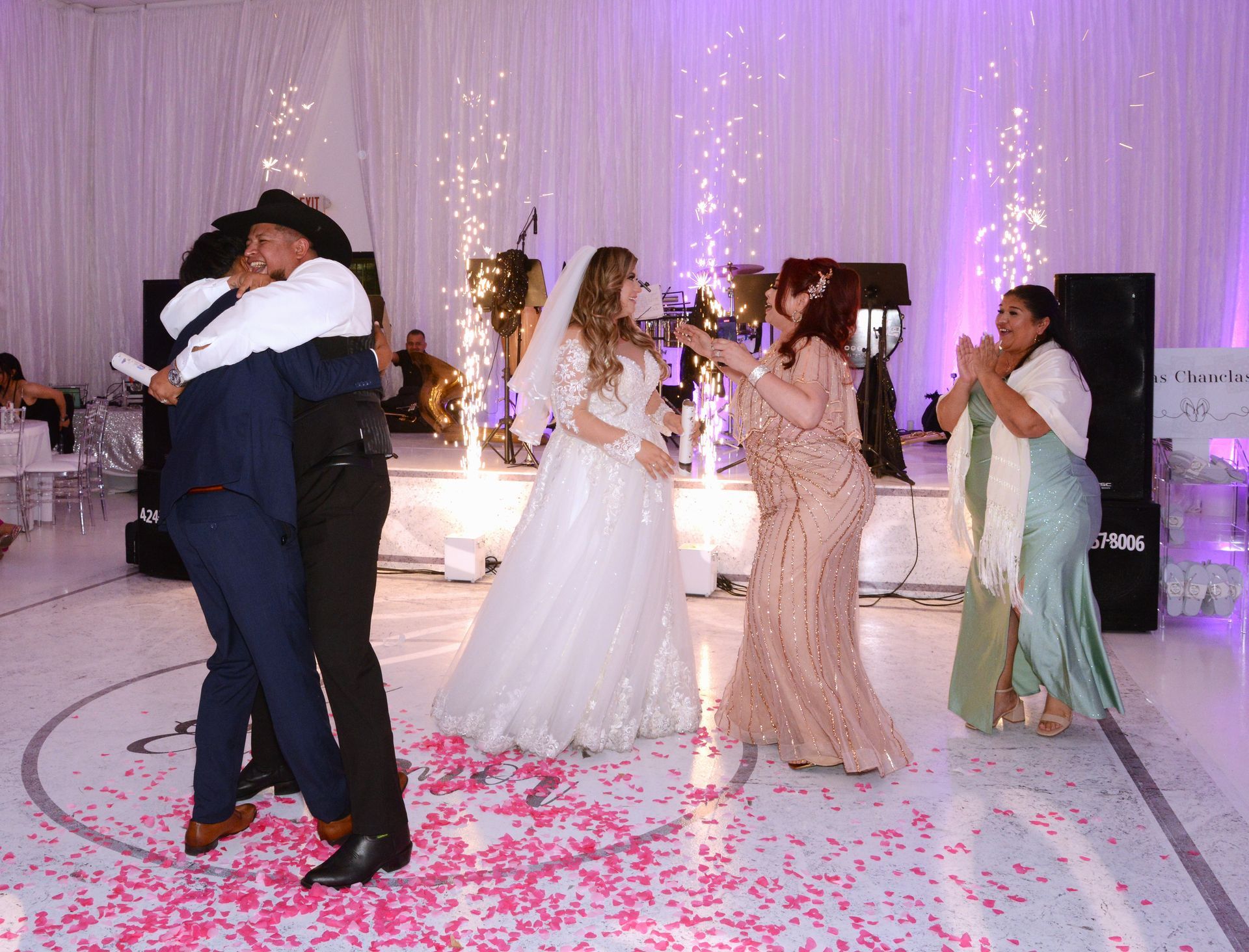 A bride and groom are getting married in front of a crowd of people at a wedding ceremony.
