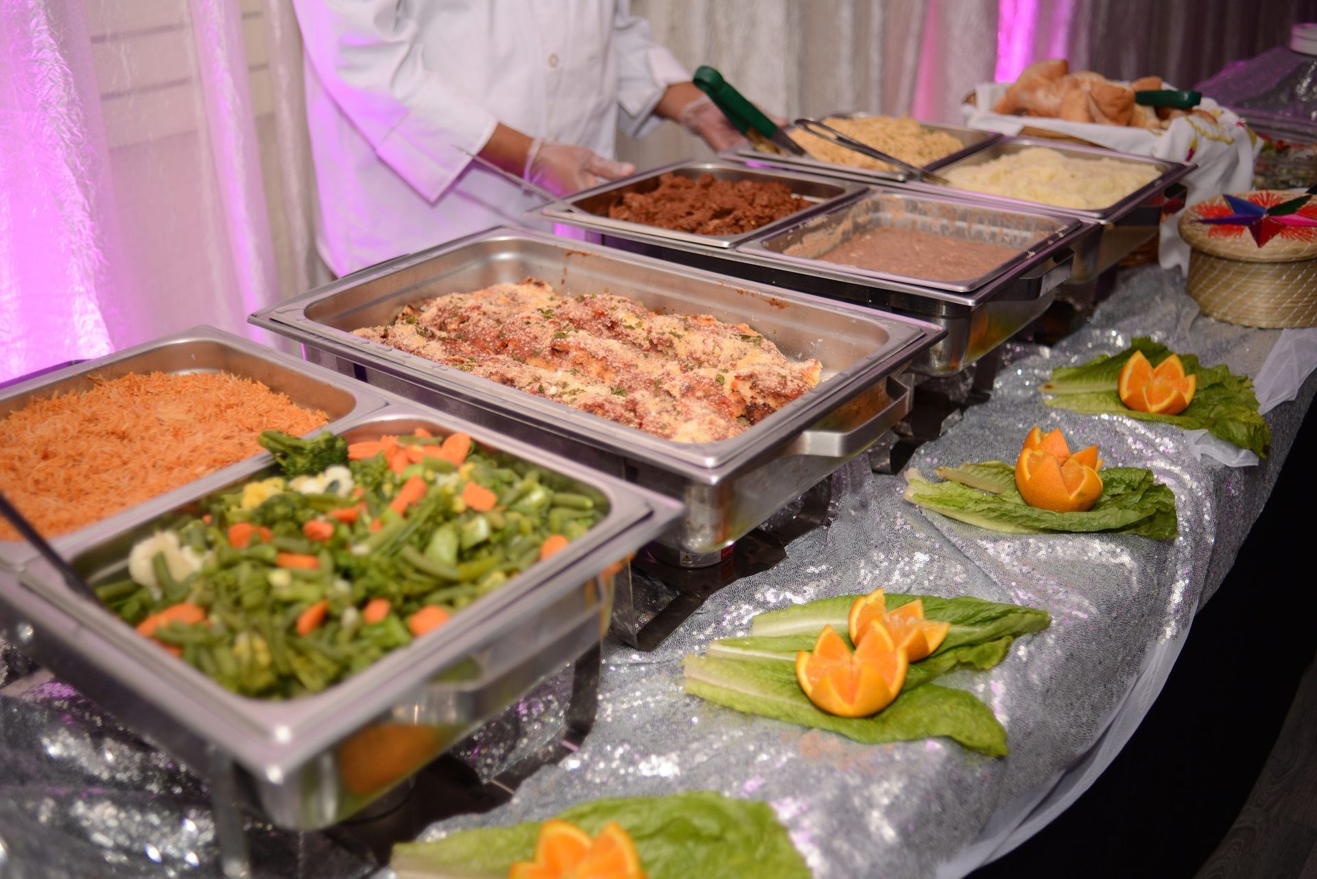 A buffet table filled with lots of different types of food.