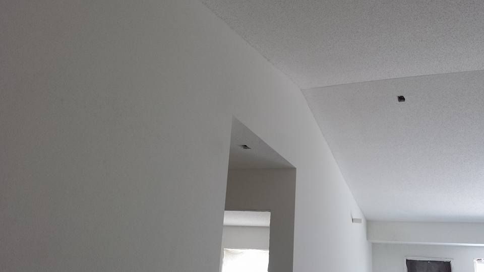 living room drywall installation with texture and a fresh white paint