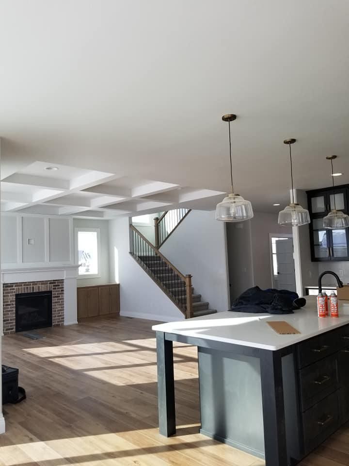 A vaulted drywall ceiling above a fireplace