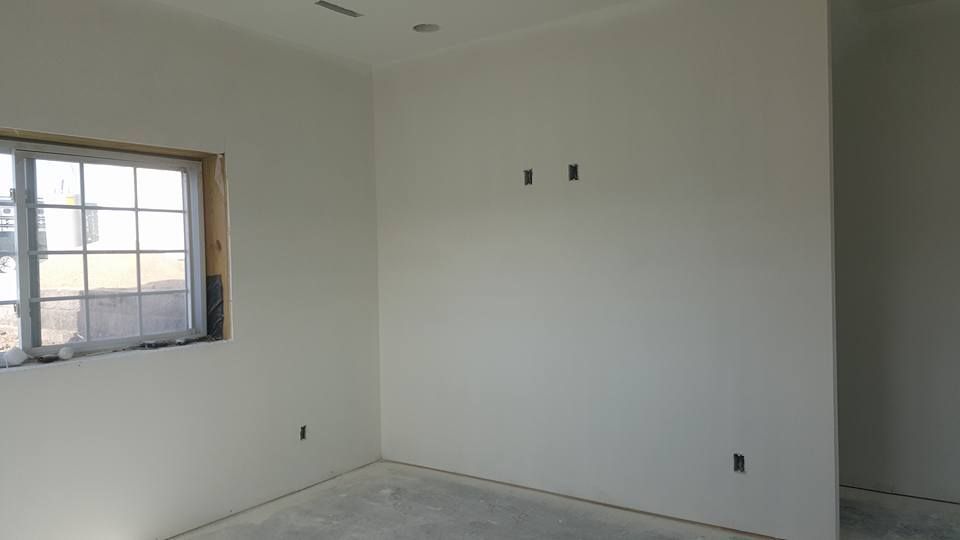 Drywall installation in a residential bedroom