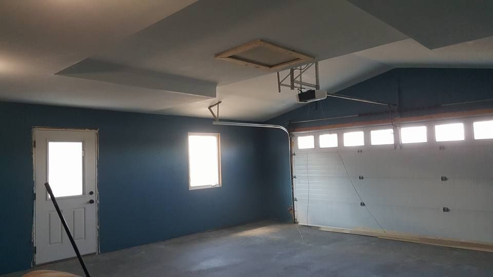 drywall installation and blue painted finish in a garage