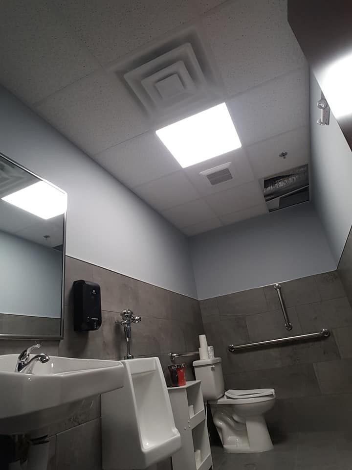 Acoustic ceiling installation in a commercial bathroom