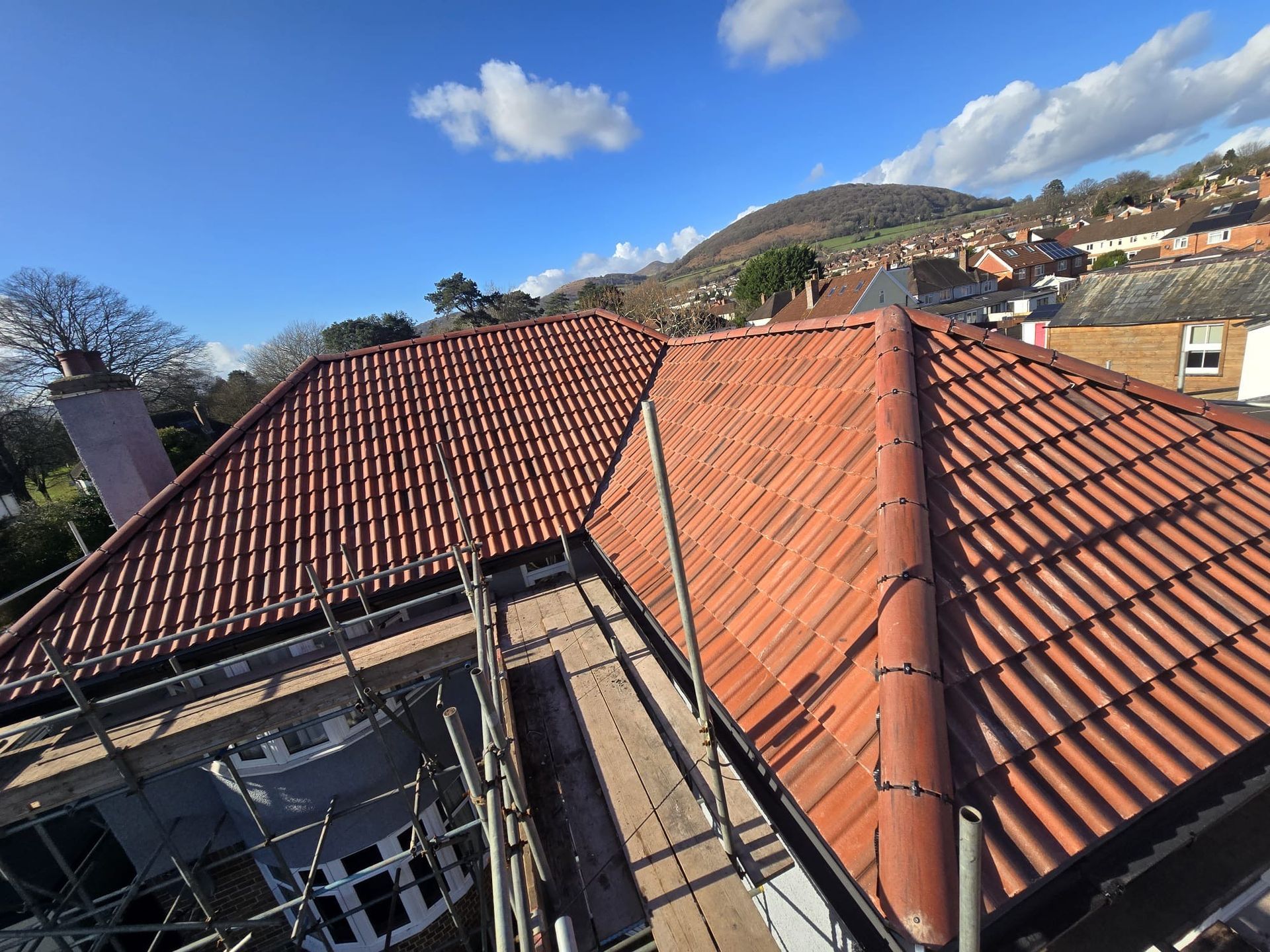An aerial view of a house with a red tiled roof.