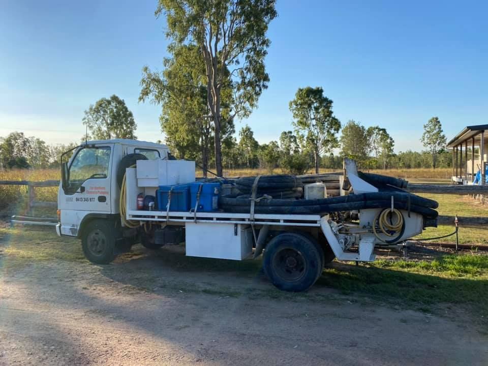 White Flatbed Truck With Equipment Parked Outdoors on a Sunny Day — Far Northern Concrete Pumping in Mareeba, QLD
