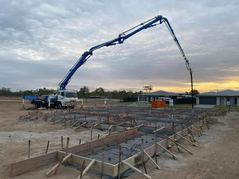 Concrete pump truck pouring concrete into a prepared foundation — Far Northern Concrete Pumping in Mareeba, QLD