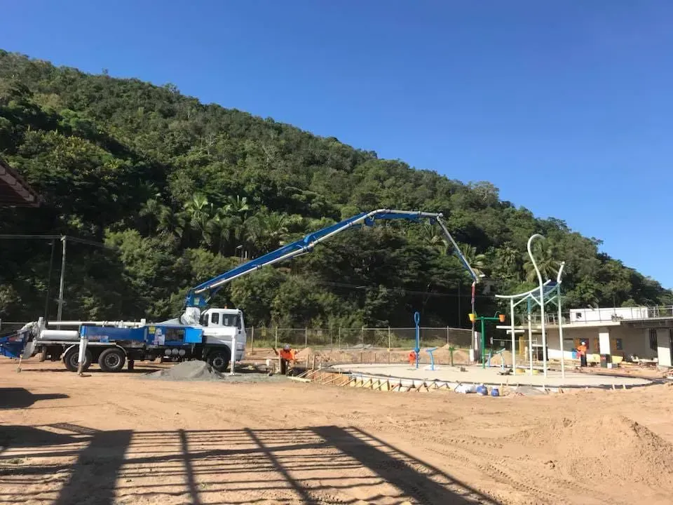 Concrete Pump Truck Pouring Concrete at a Construction Site — Far Northern Concrete Pumping in Mareeba, QLD