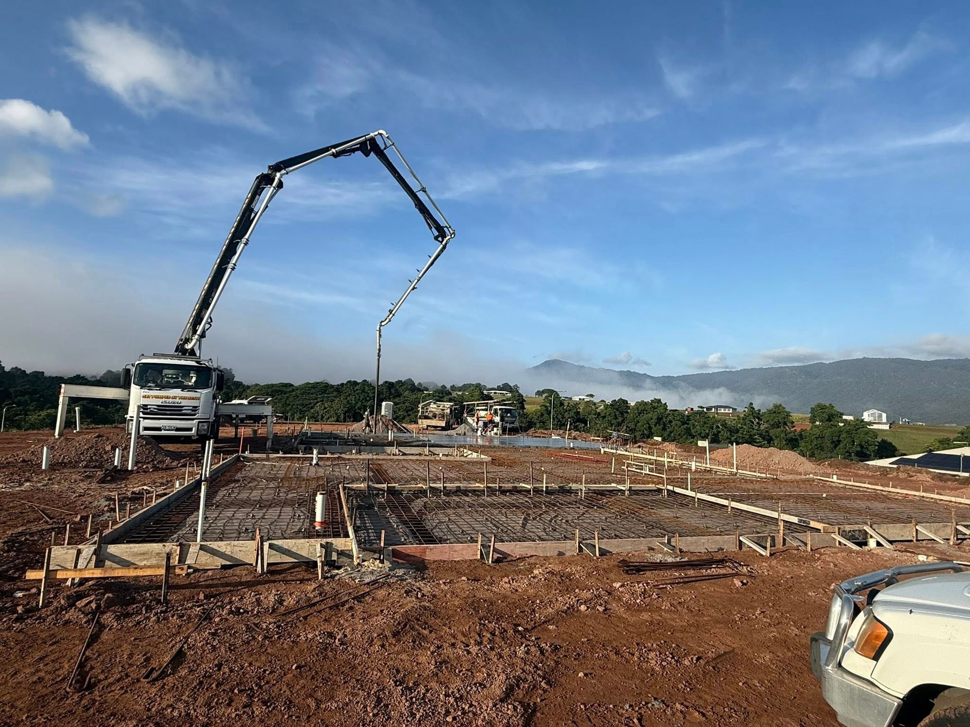Concrete Pump Truck Pouring Concrete Into a Prepared Foundation — Far Northern Concrete Pumping in Mareeba, QLD