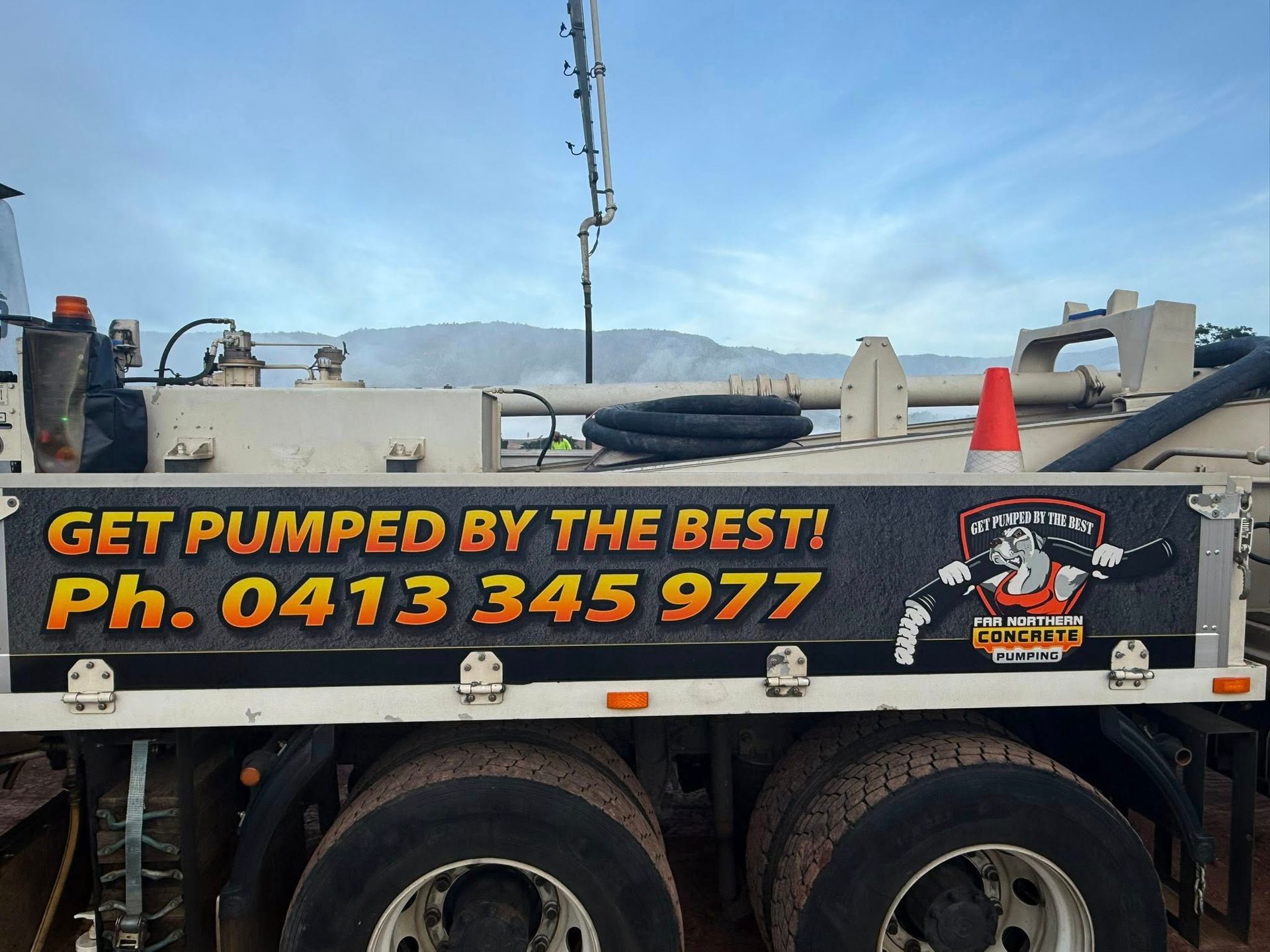 Concrete Pumping Truck With Advertising Text — Far Northern Concrete Pumping in Mareeba, QLD