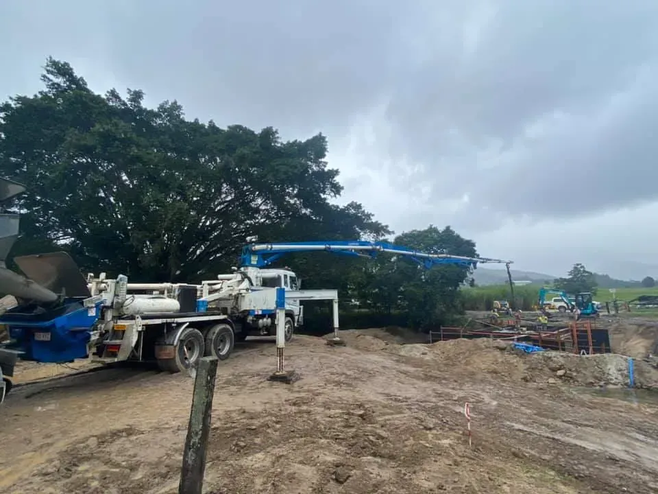 Concrete Pump Truck Pouring Concrete at a Construction Site — Far Northern Concrete Pumping in Mareeba, QLD