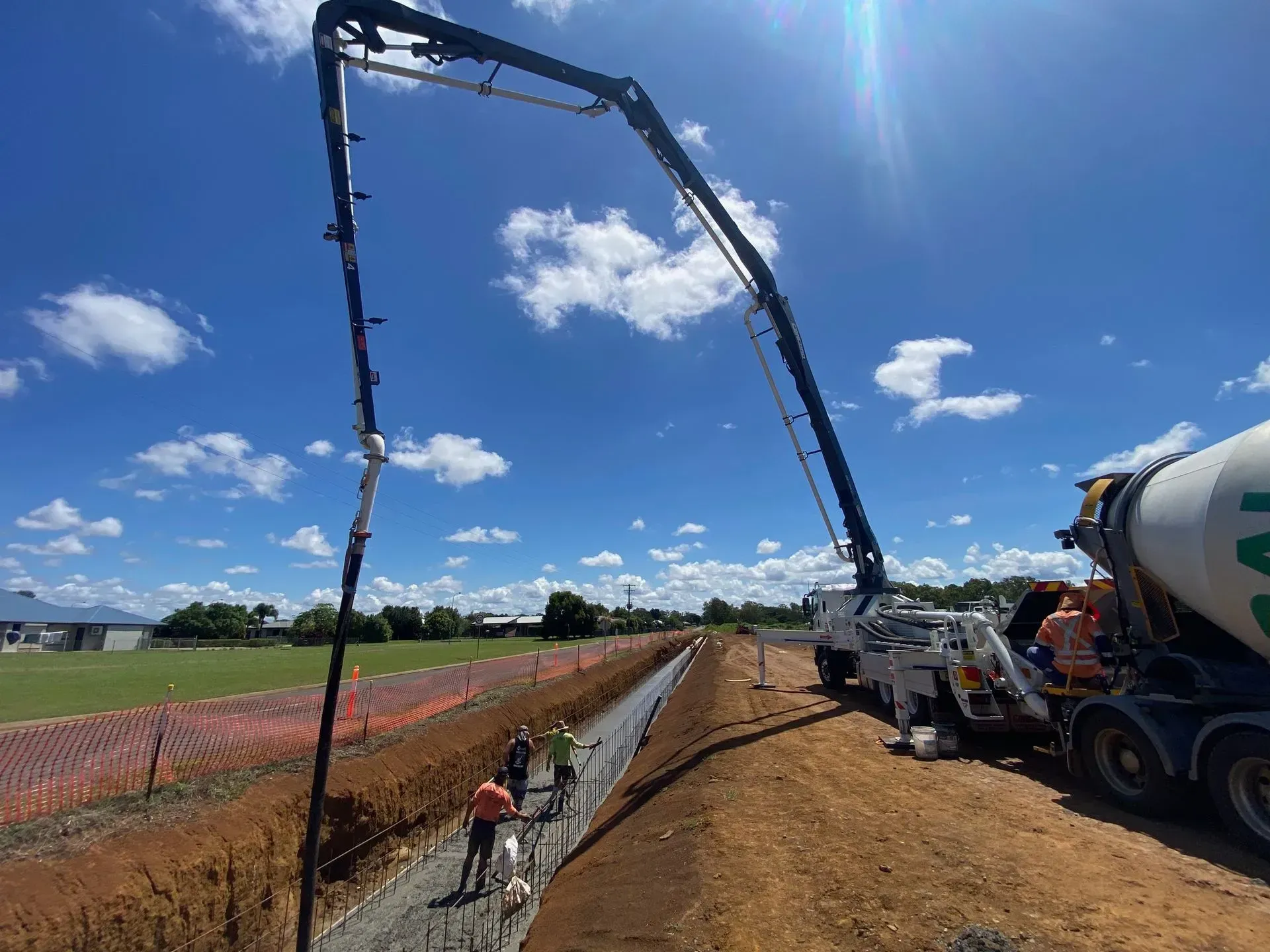 Concrete Pouring Construction Site With Truck and Boom Arm — Far Northern Concrete Pumping in Mareeba, QLD