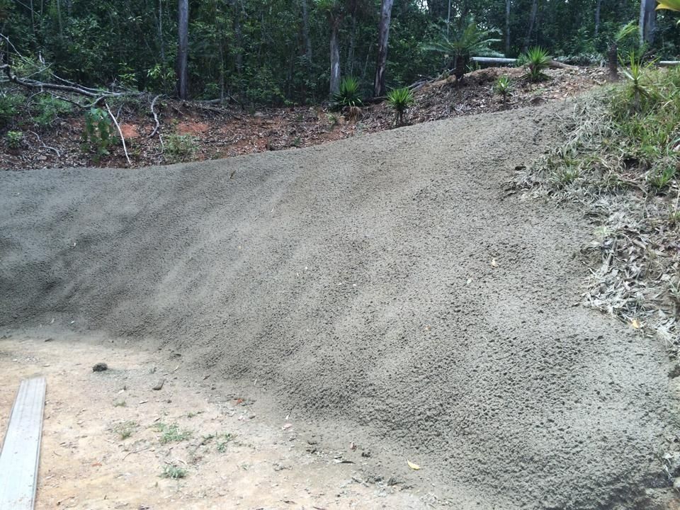 A Sloped, Gravel-covered Surface Leading to a Treeline — Far Northern Concrete Pumping in Cairns, QLD