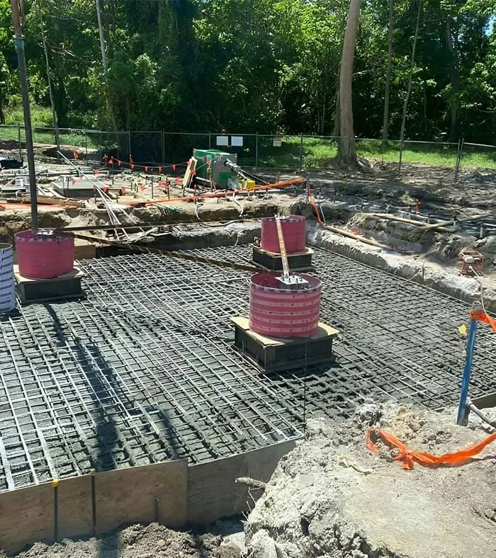 Construction Site With Rebar Grid and Cylindrical Concrete Forms — Far Northern Concrete Pumping in Croydon, QLD