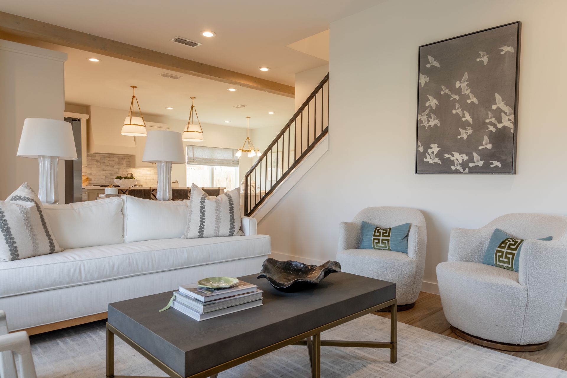 The living room of a home built by BB homes. The kitchen can be seen in the back.