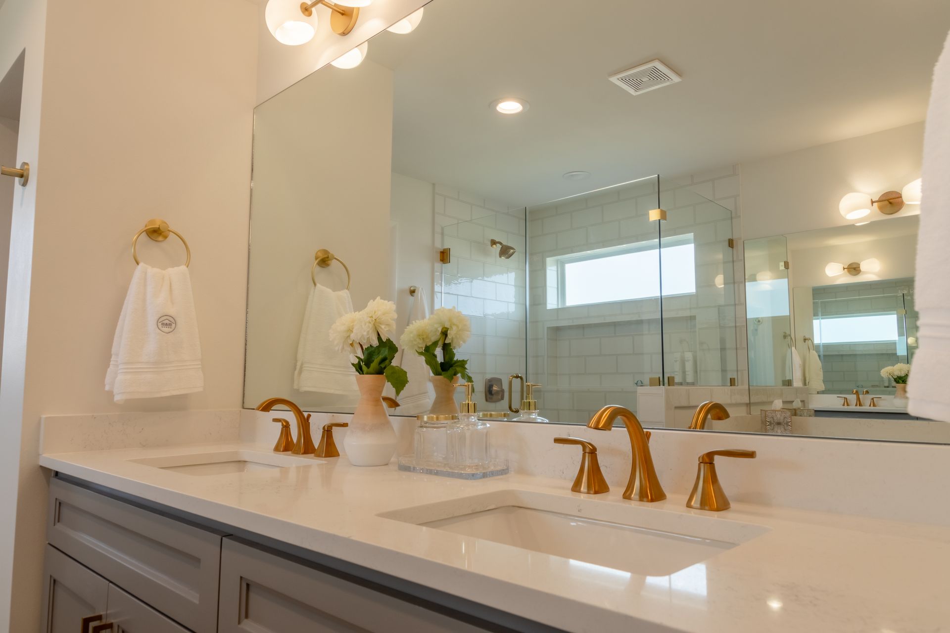 The bathroom mirror and sink of a home built by BB Homes.