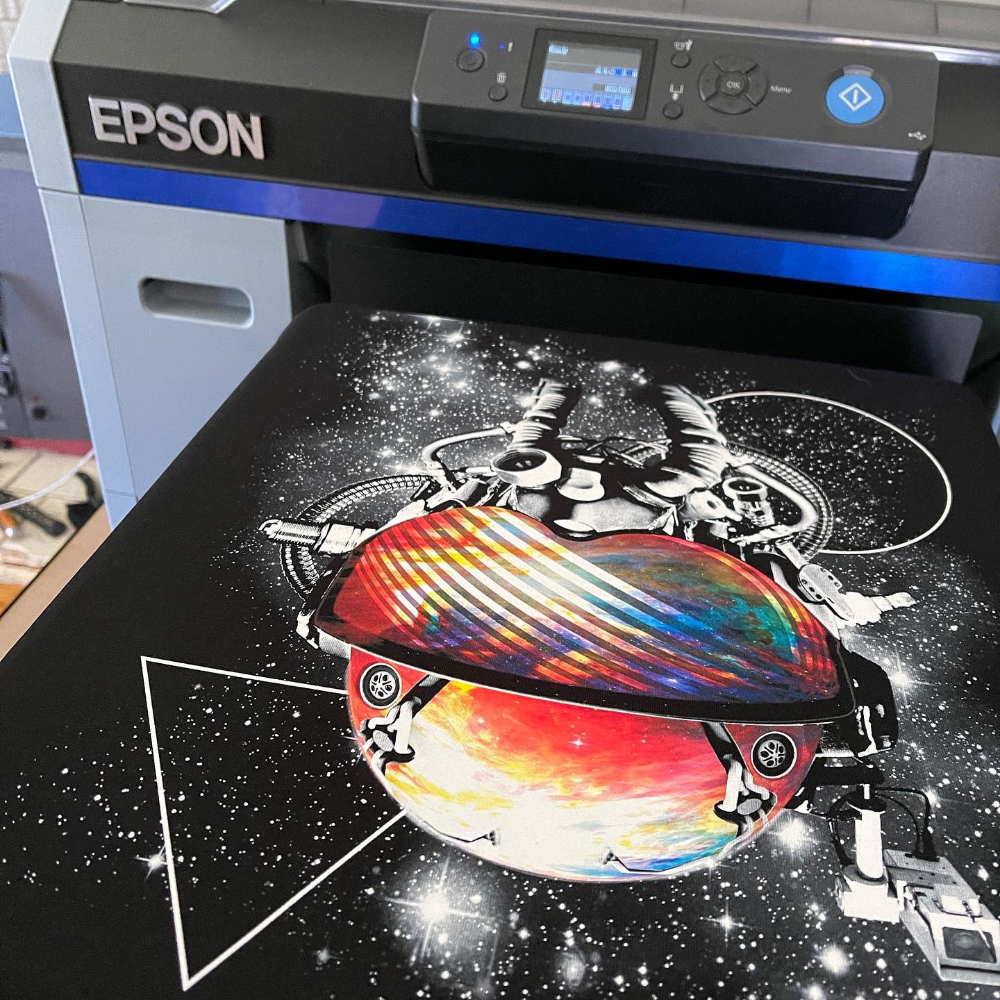 Epson SC-F2160 DTG printer with a print example on a black t-shirt.