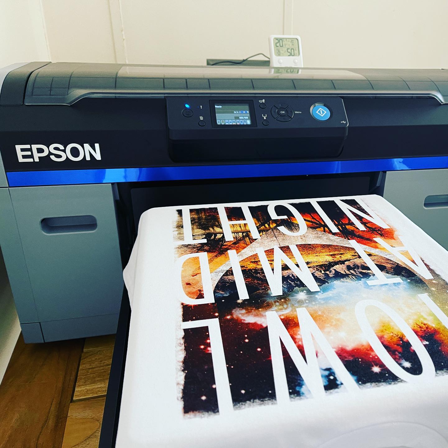 Epson SC-F2160 DTG printer with a print example on a white t-shirt.