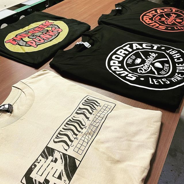 t-shirts folded neatly on a table with graphical prints