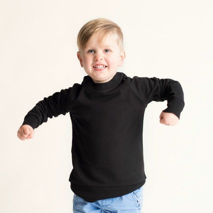 Toddler wearing a black crew neck jumper