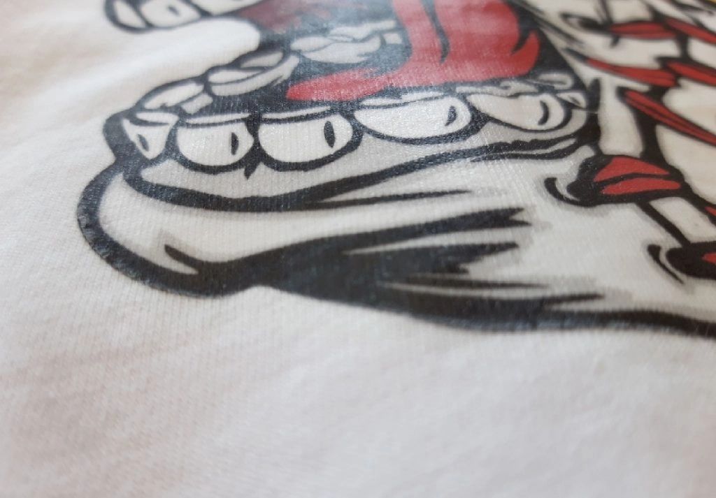 close up of a DTF print on a white t-shirt showing the ink has boned with the garment.