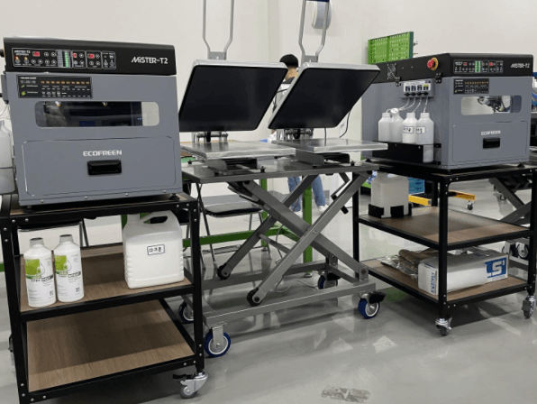 Mister T2 Pretreatment Machine on stands with heat press