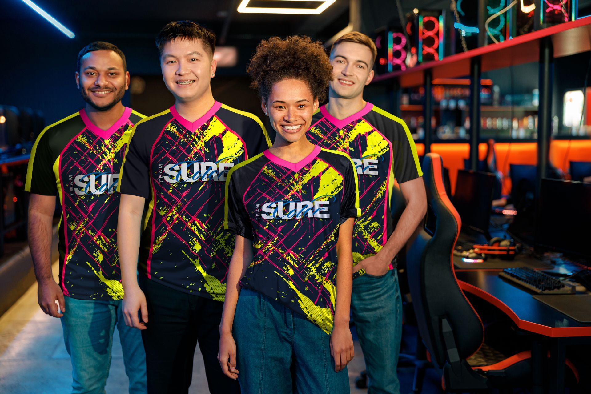 Group of young people smiling at the camera wearing dye-sublimated t-shirts for gaming.