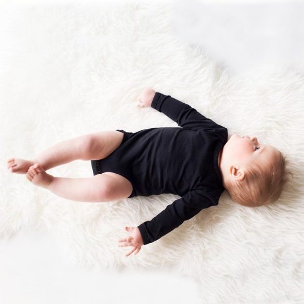 baby wearing a black long sleeve bodysuit