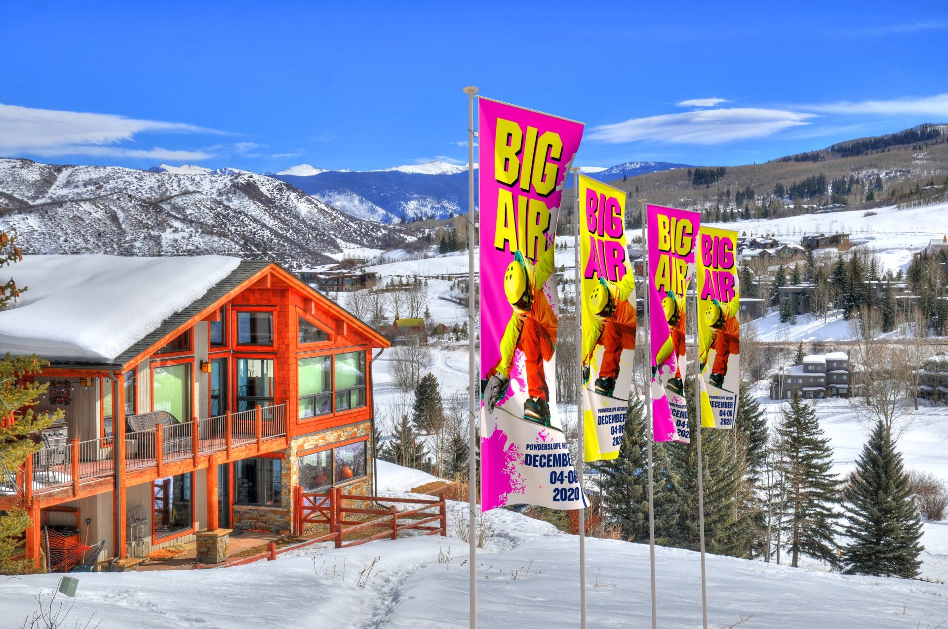 Ski slopes with a log building, large dye sub flags at the front