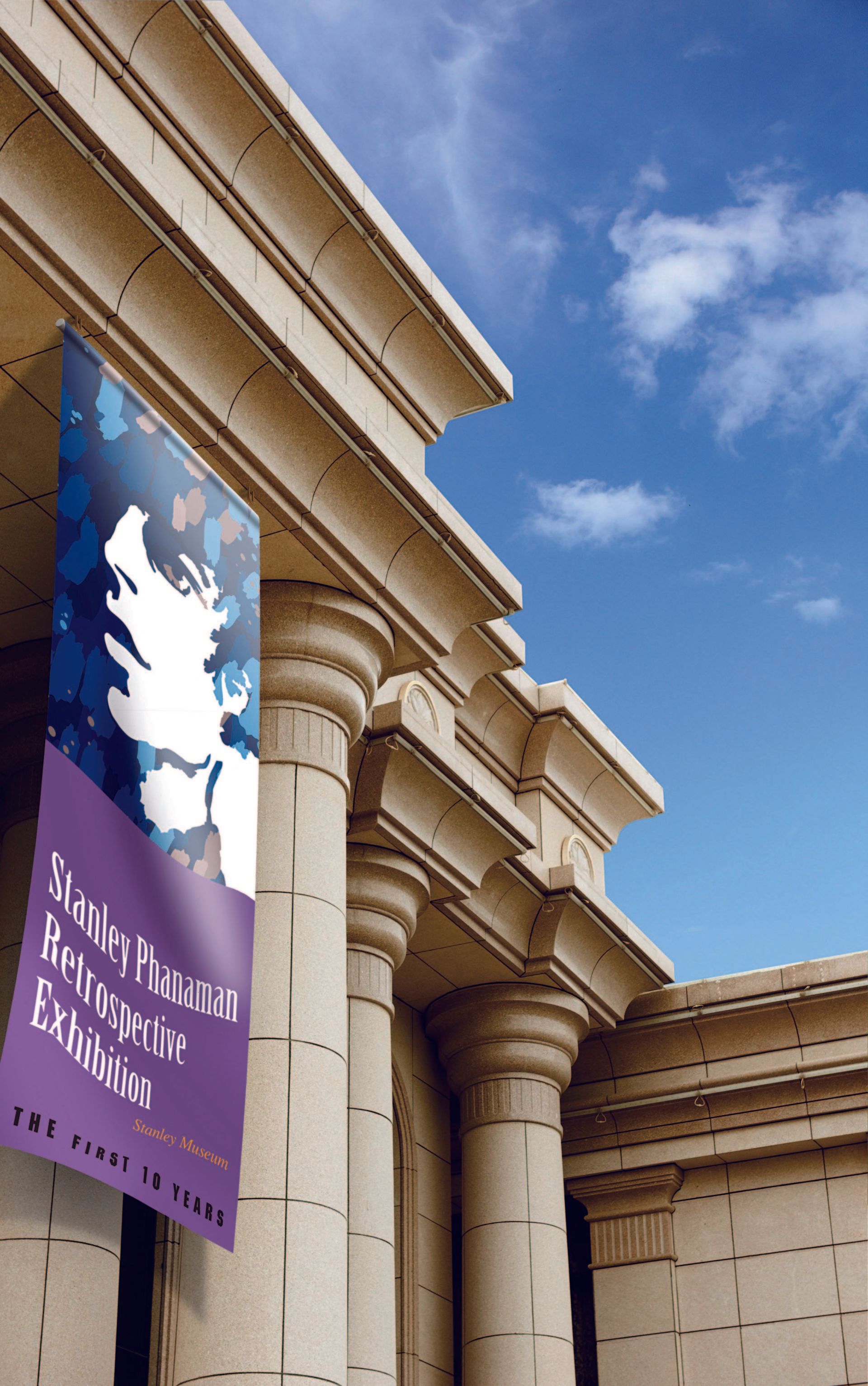 Soft signage hanging from a stone building, blue skies